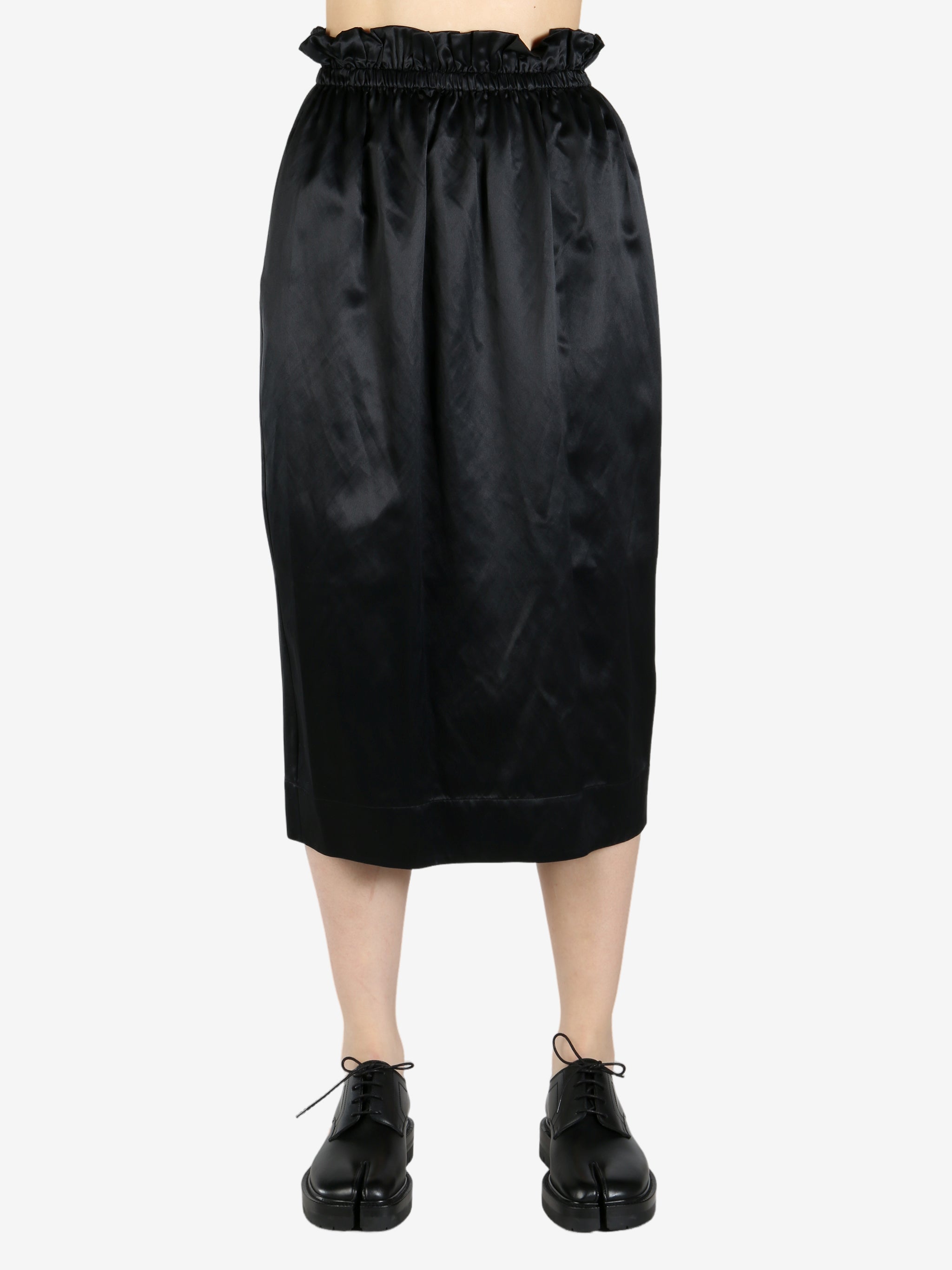 black skirt worn by a person, showing the skirt fit
