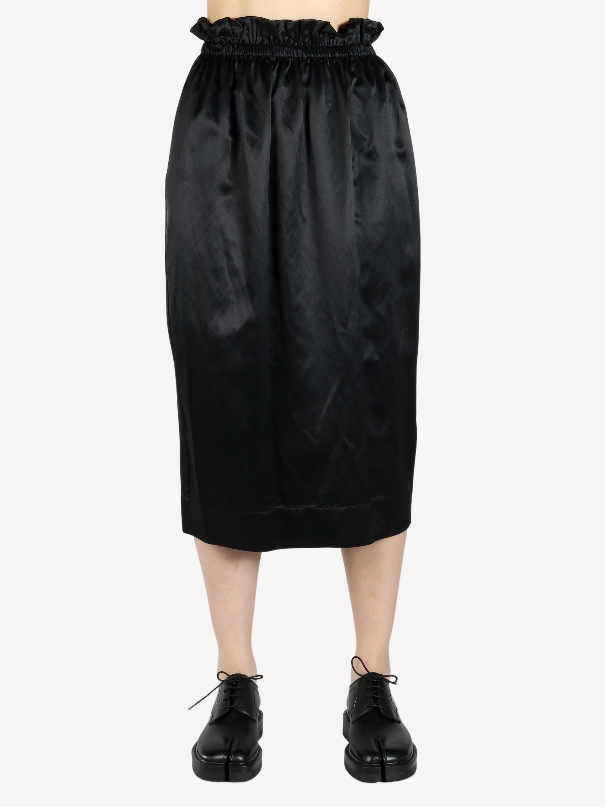 black skirt worn by a person, showing the skirt fit
