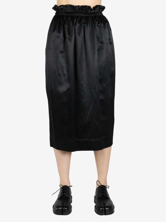 black skirt worn by a person, showing the skirt fit

