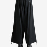 Black pants worn by a person, showing the pants fit