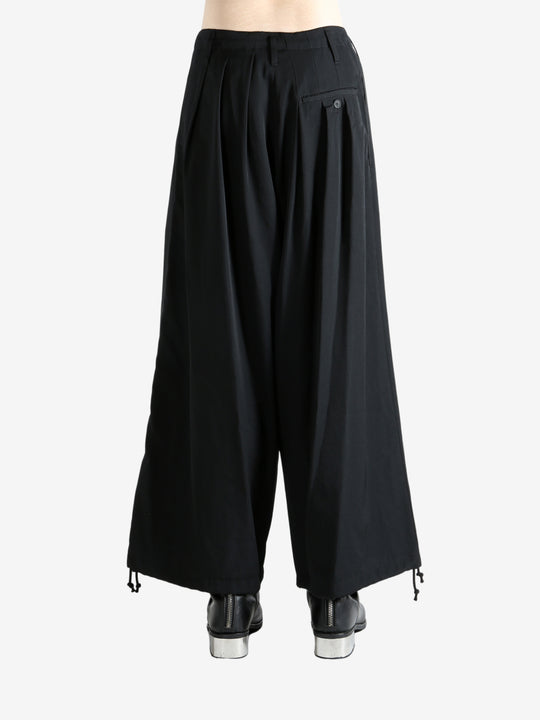 Black pants worn by a person, showing the pants fit