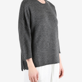 Grey knitwear worn by a person, showing the knitwear fit