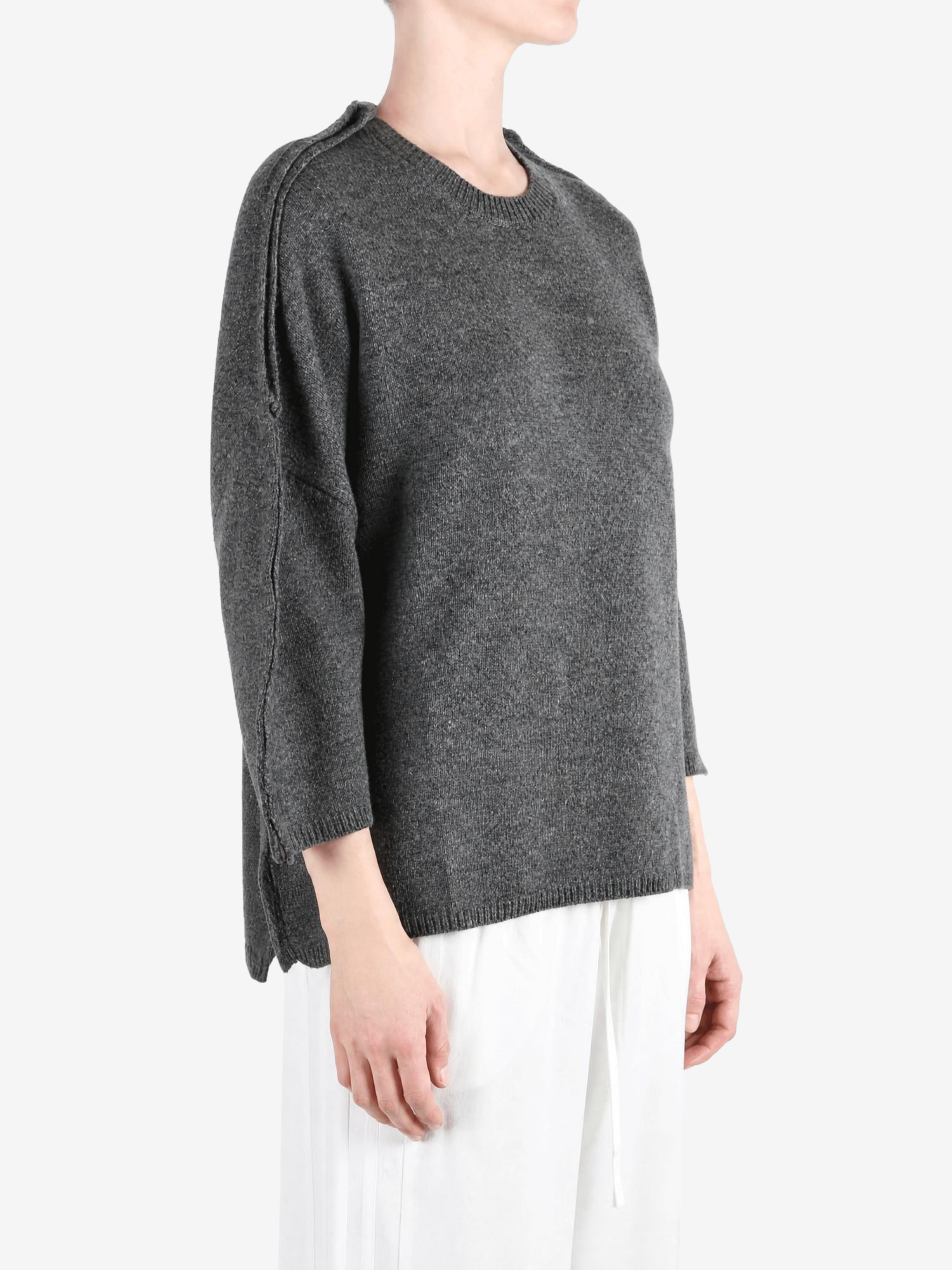 Grey knitwear worn by a person, showing the knitwear fit