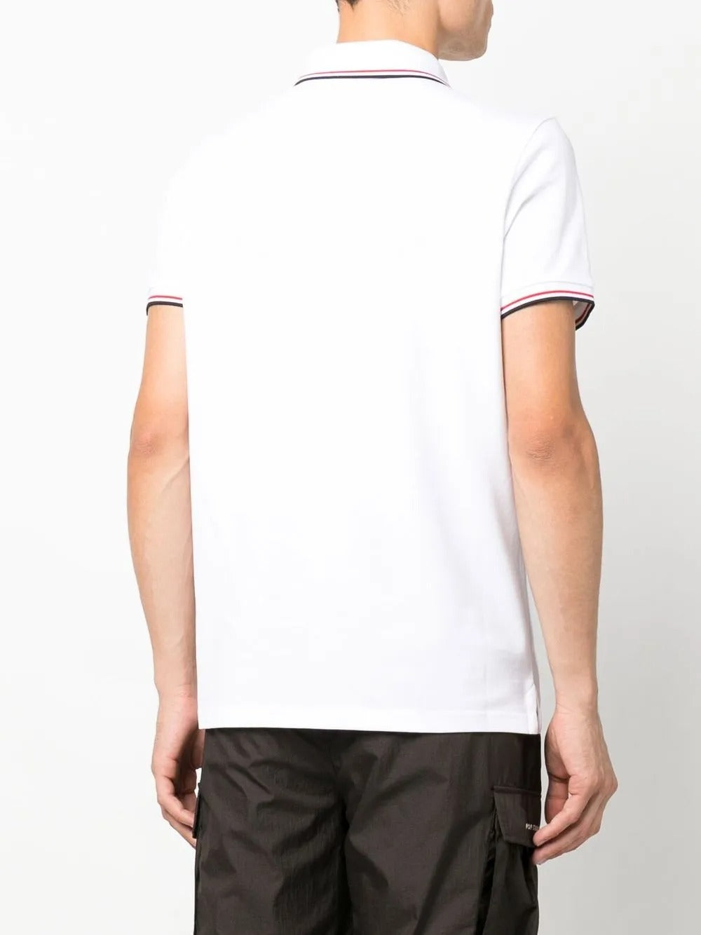 White shirt worn by a person, showing the shirt's fit