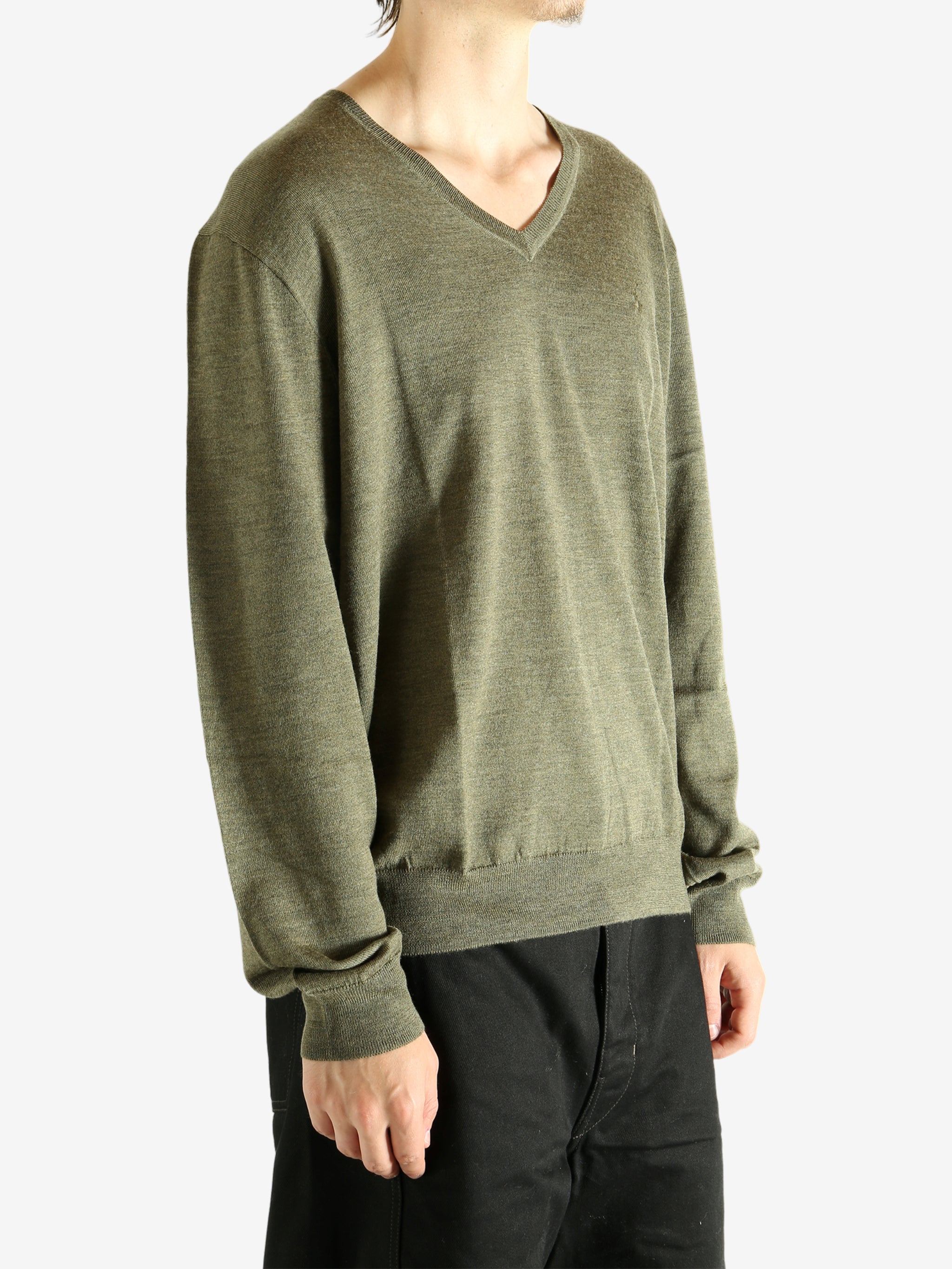 Green sweater worn by a person, showing the sweater's fit