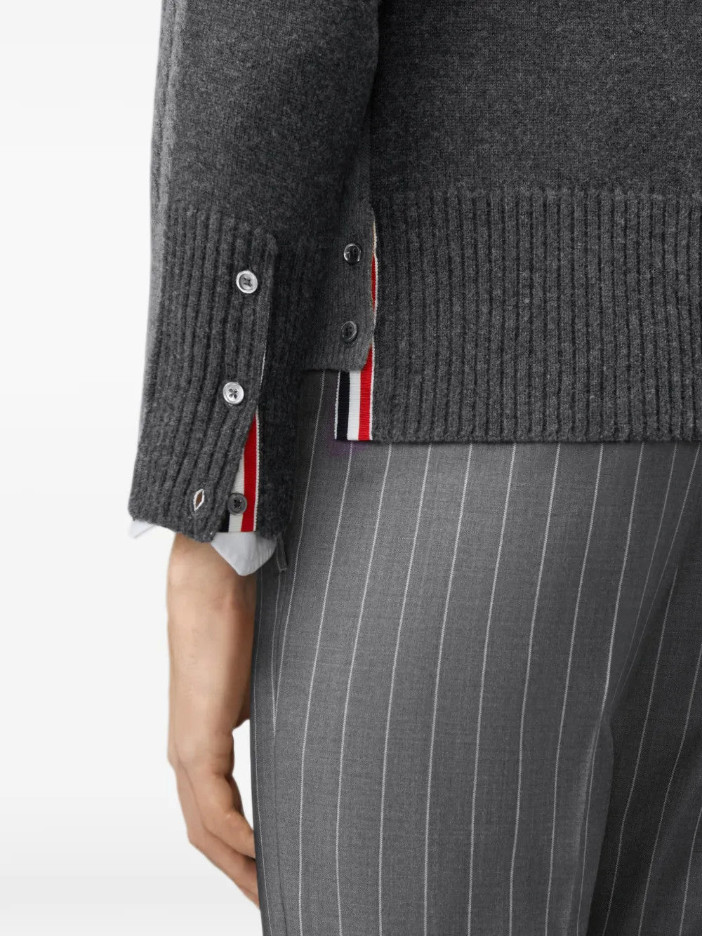 Grey knitwear worn by a person, showing the knitwear fit