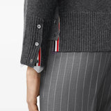Grey knitwear worn by a person, showing the knitwear fit
