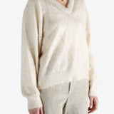 Tan knitwears worn by a person, showing the knitwears fit