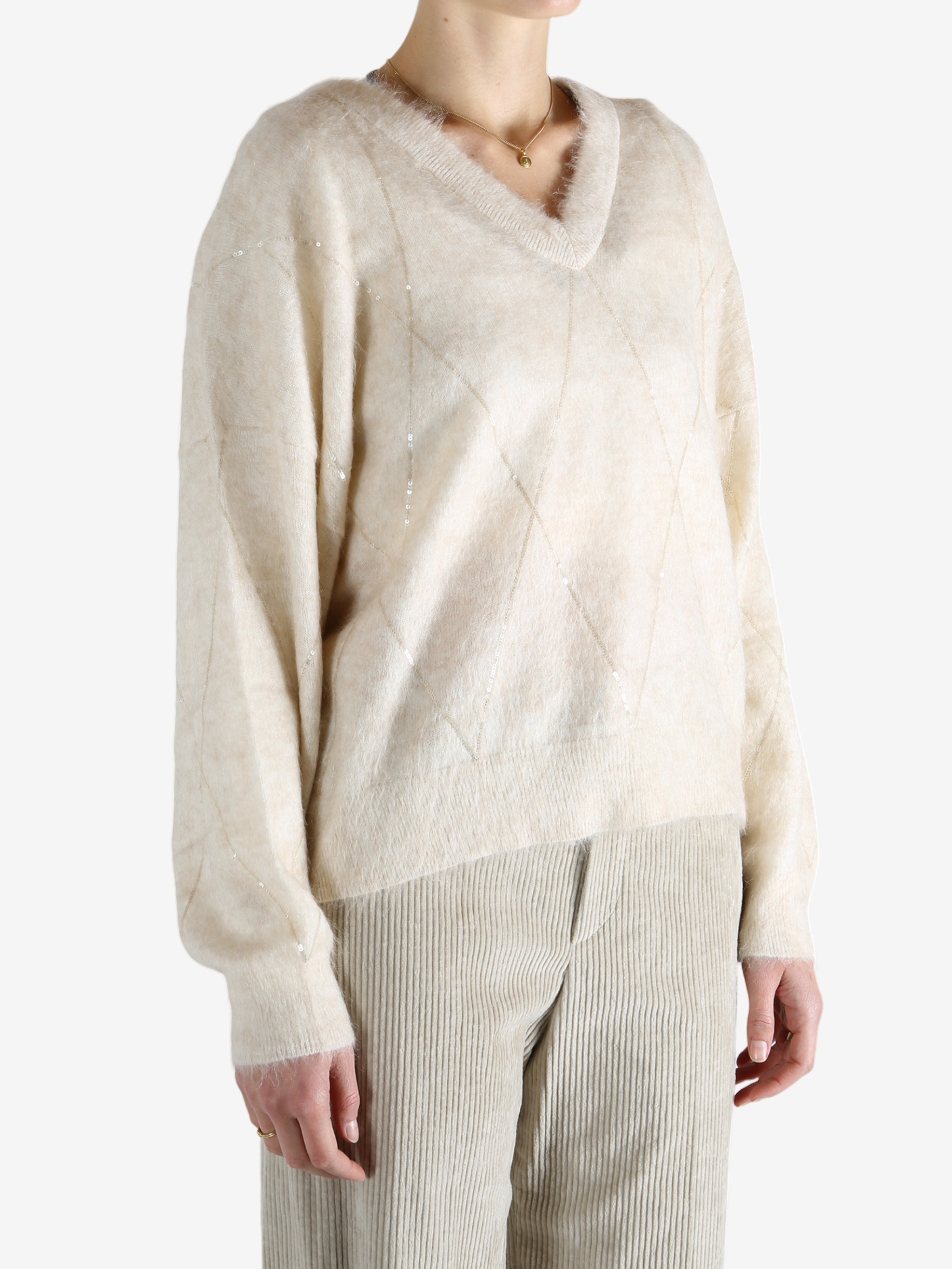 Tan knitwears worn by a person, showing the knitwears fit