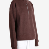 Brown hoodie worn by a person, showing the hoodie fit