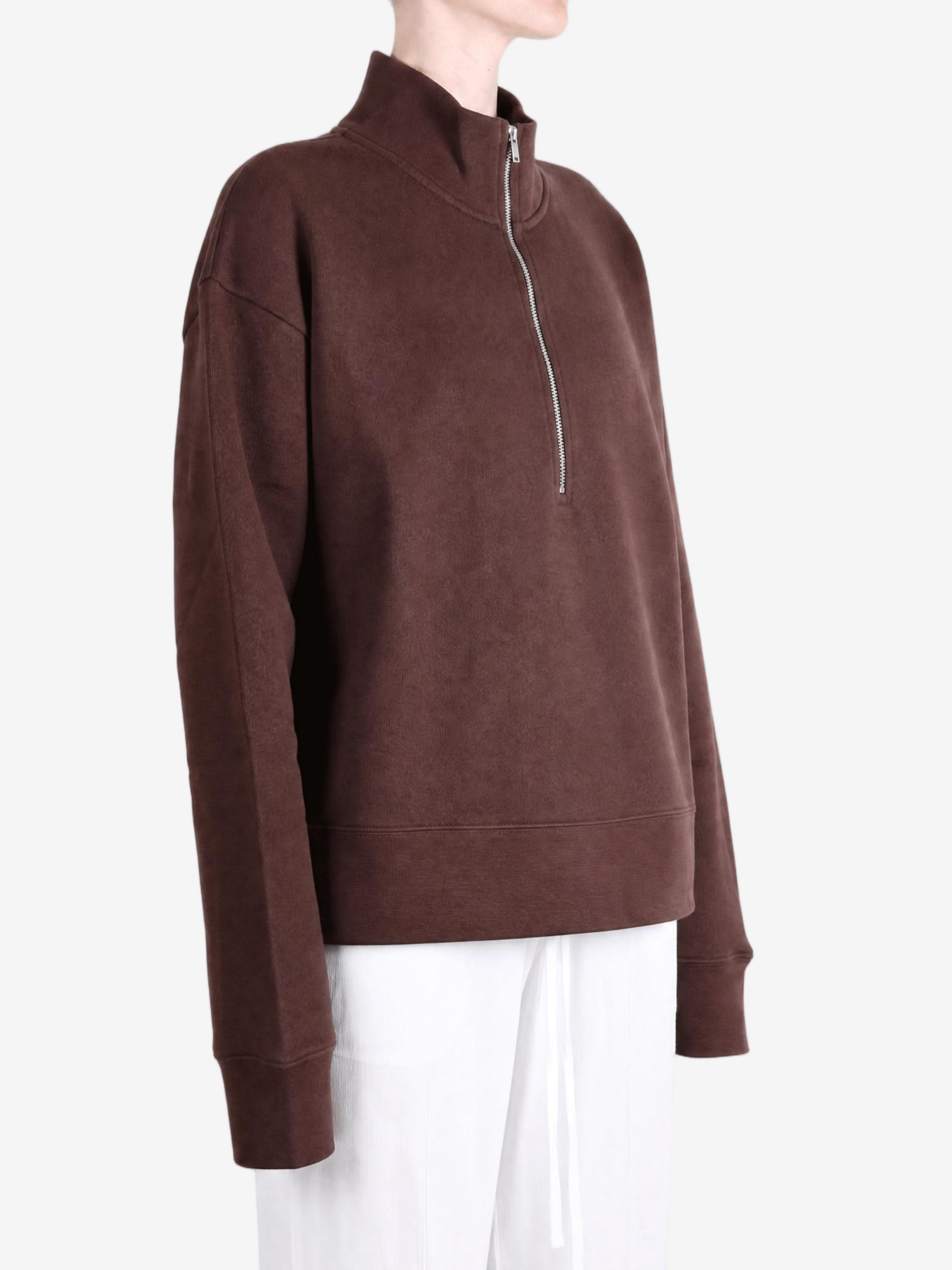 Brown hoodie worn by a person, showing the hoodie fit