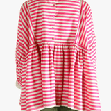 Red top worn by a person, showing the top's fit