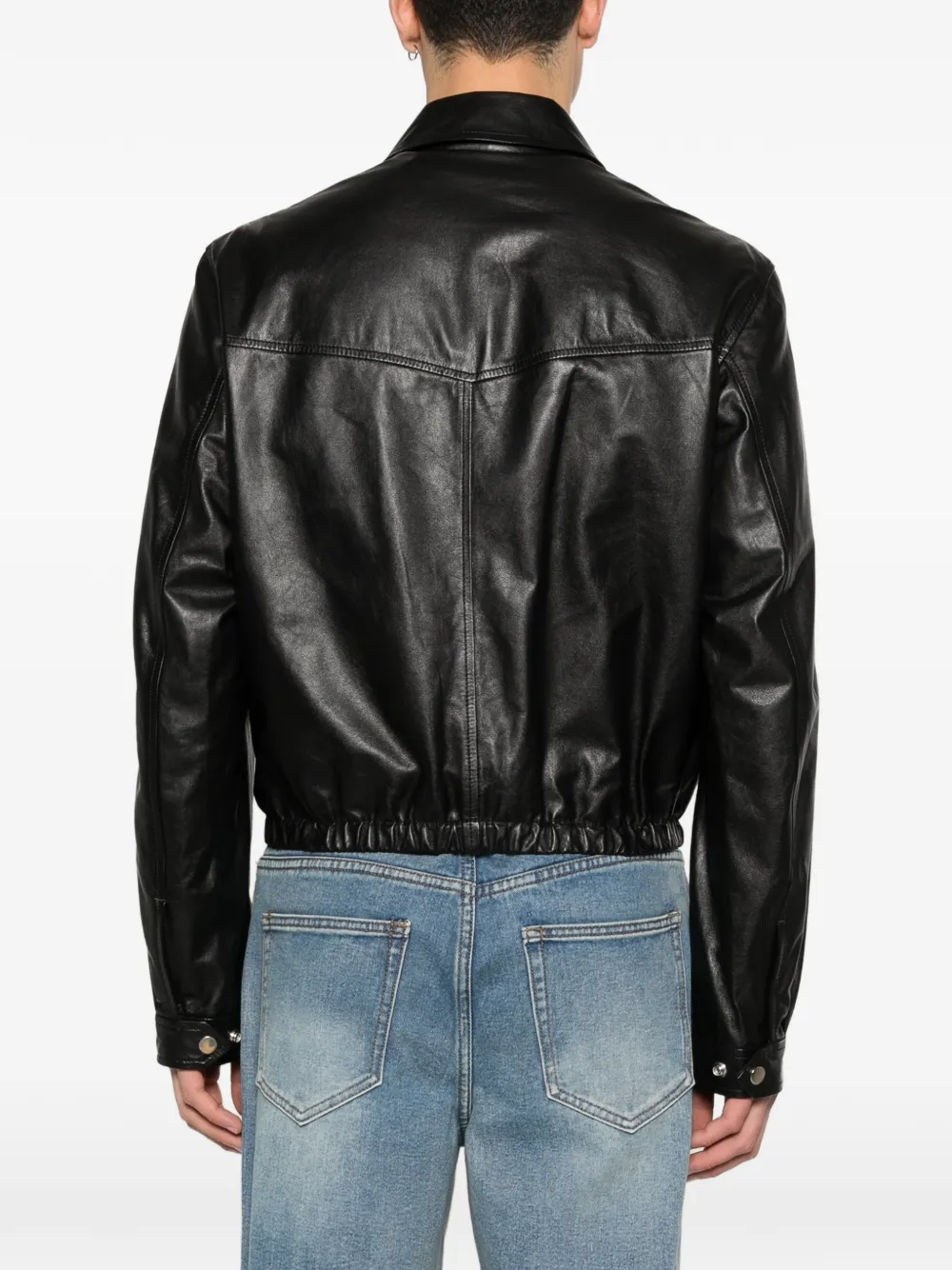 Black leather jacket worn by a person, showing the jacket fit
