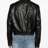 Black leather jacket worn by a person, showing the jacket fit