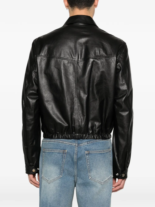 Black leather jacket worn by a person, showing the jacket fit