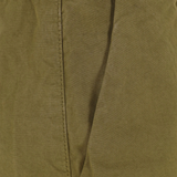 Close up of green pants, showing texture of the cotton fabric