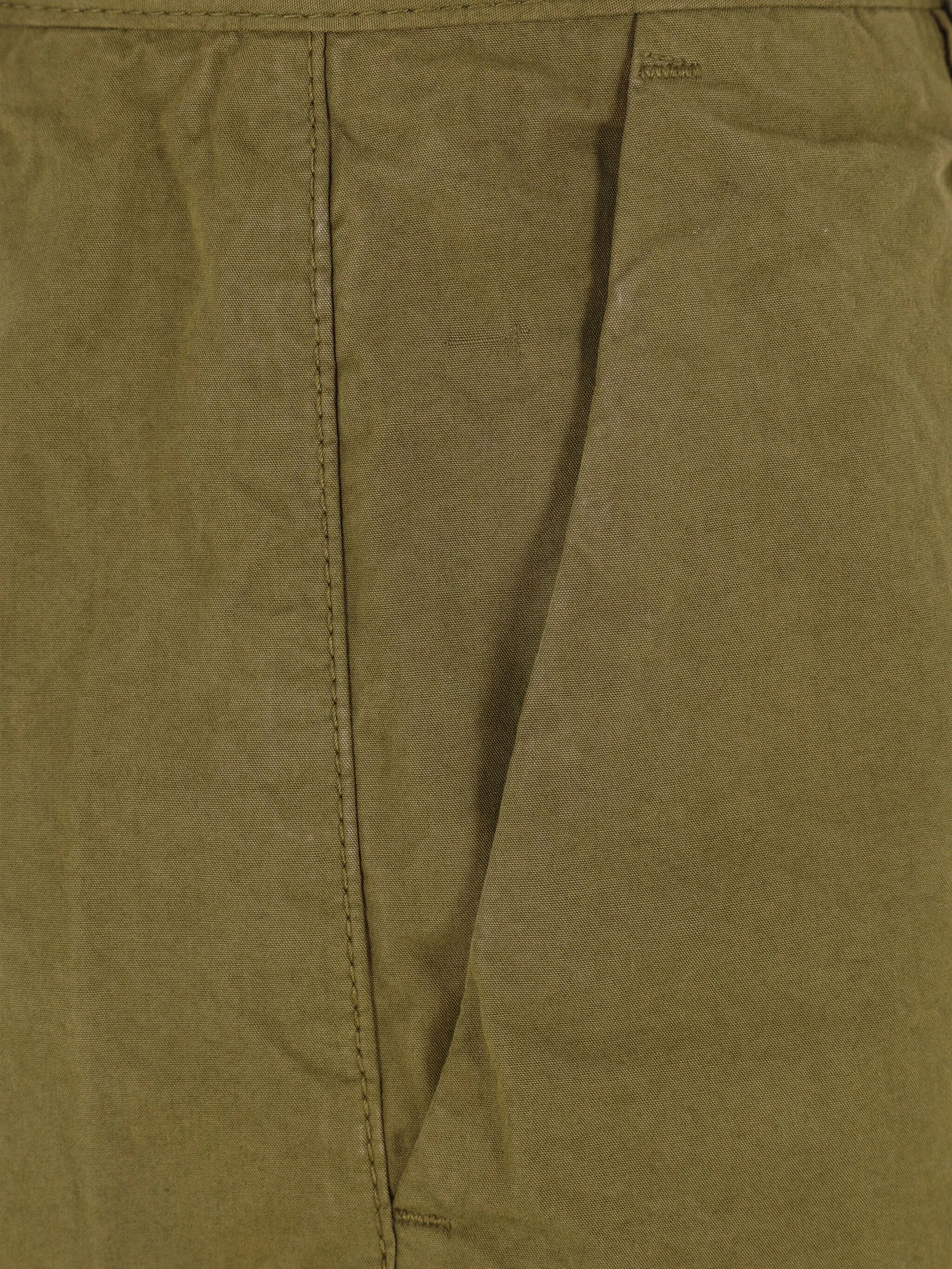 Close up of green pants, showing texture of the cotton fabric