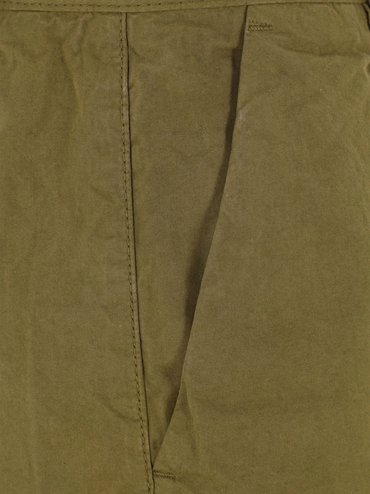 Close up of green pants, showing texture of the cotton fabric
