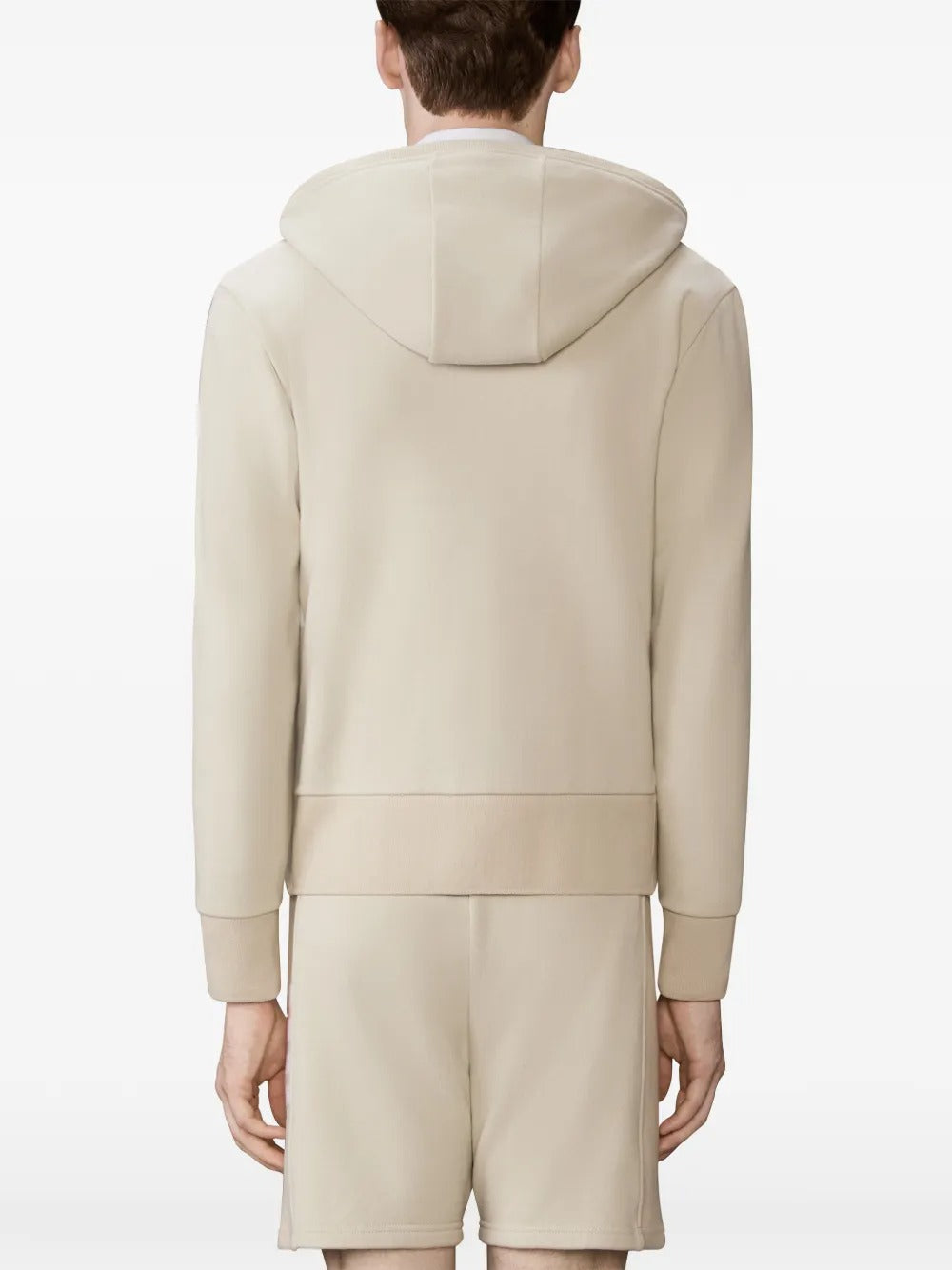 Tan hoodies worn by a person, showing the hoodies fit