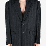 Black jacket worn by a person, showing the jacket's fit