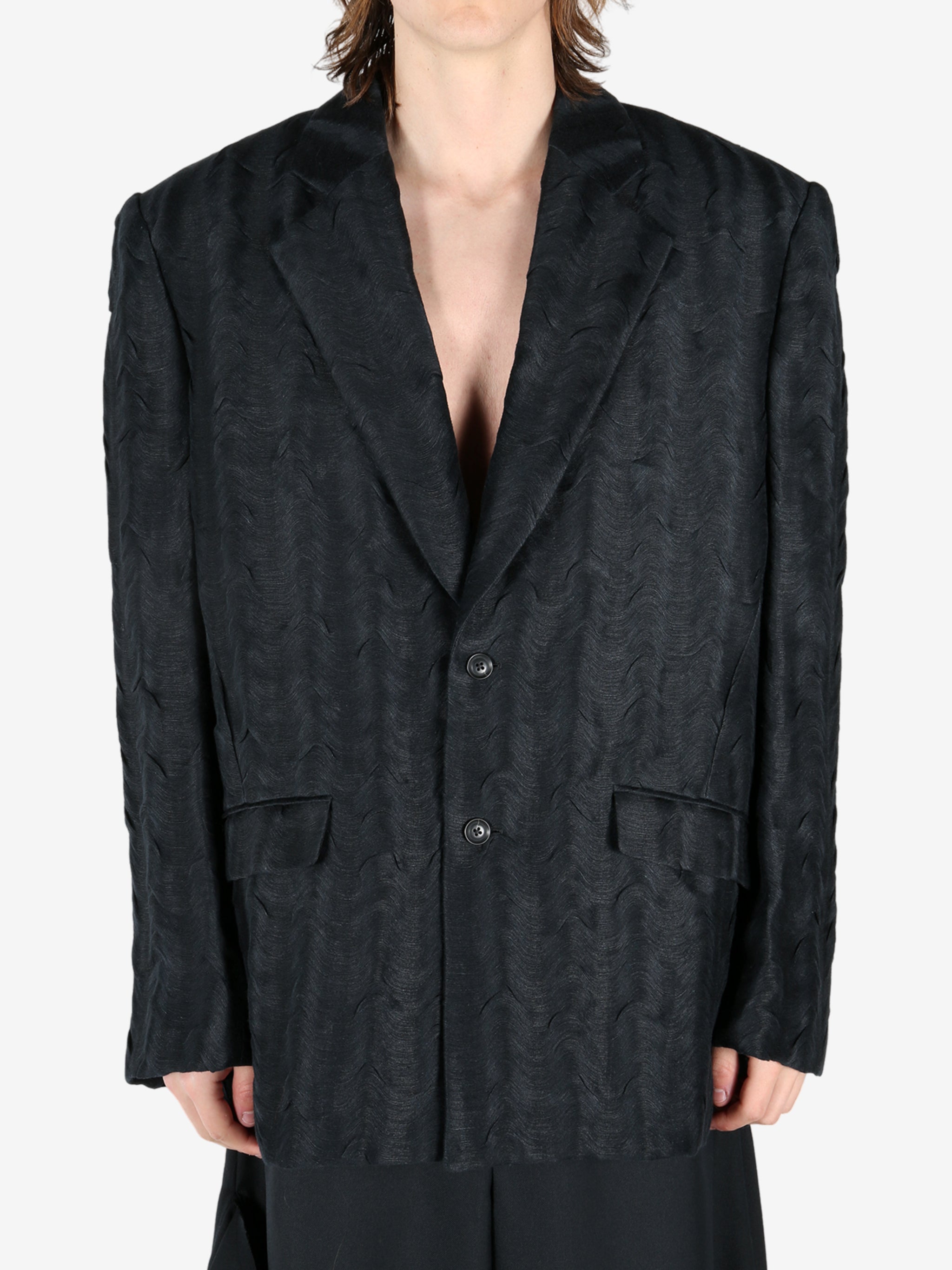 Black jacket worn by a person, showing the jacket's fit
