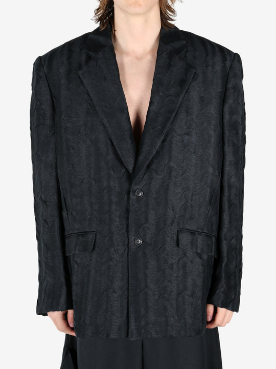 Black jacket worn by a person, showing the jacket's fit