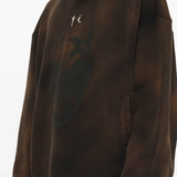 Brown hoodie worn by a person, showing the hoodie fit