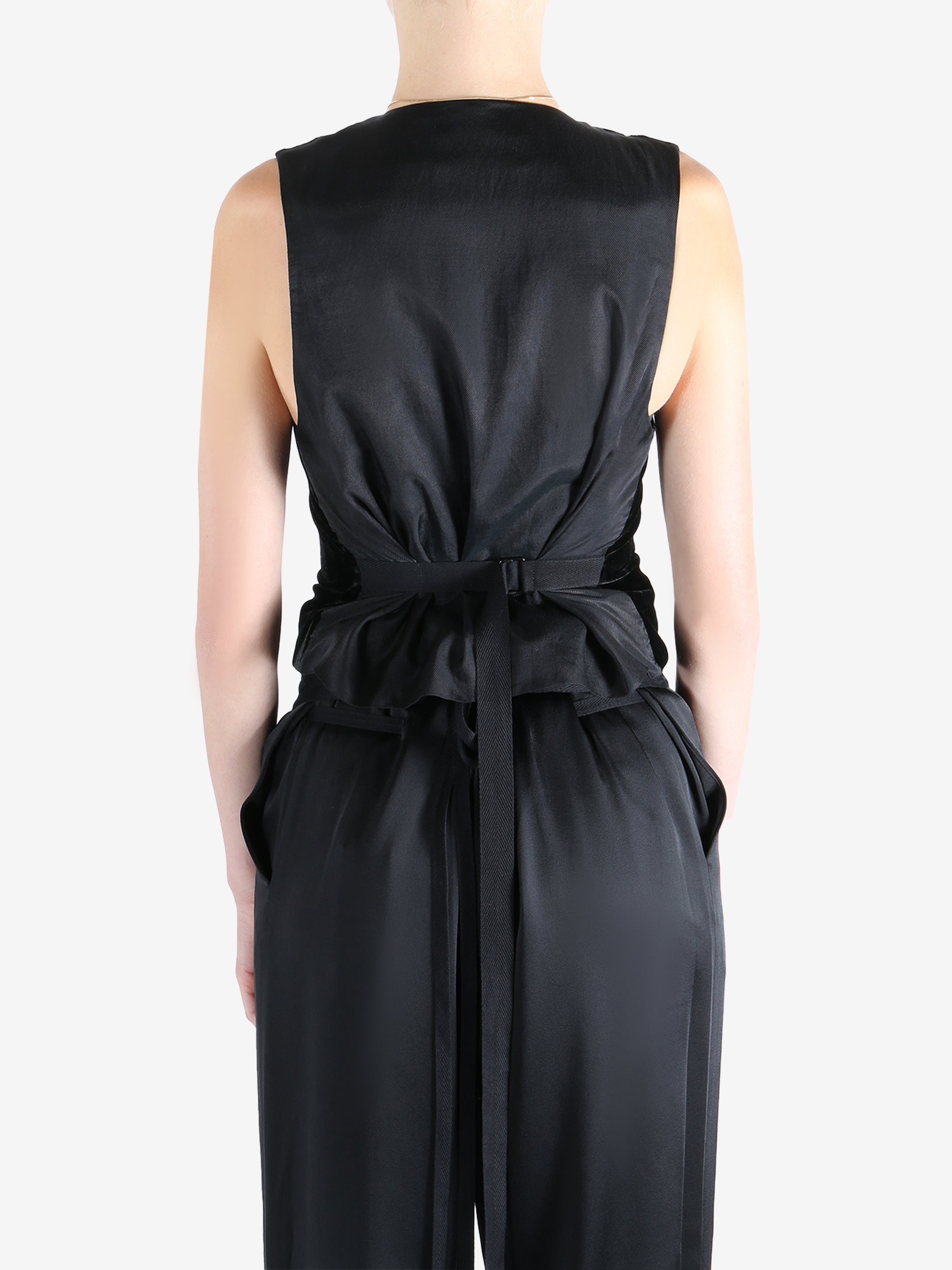 Black coat worn by a person, showing the coat's fit