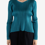 Green top worn by a person, showing the top fit