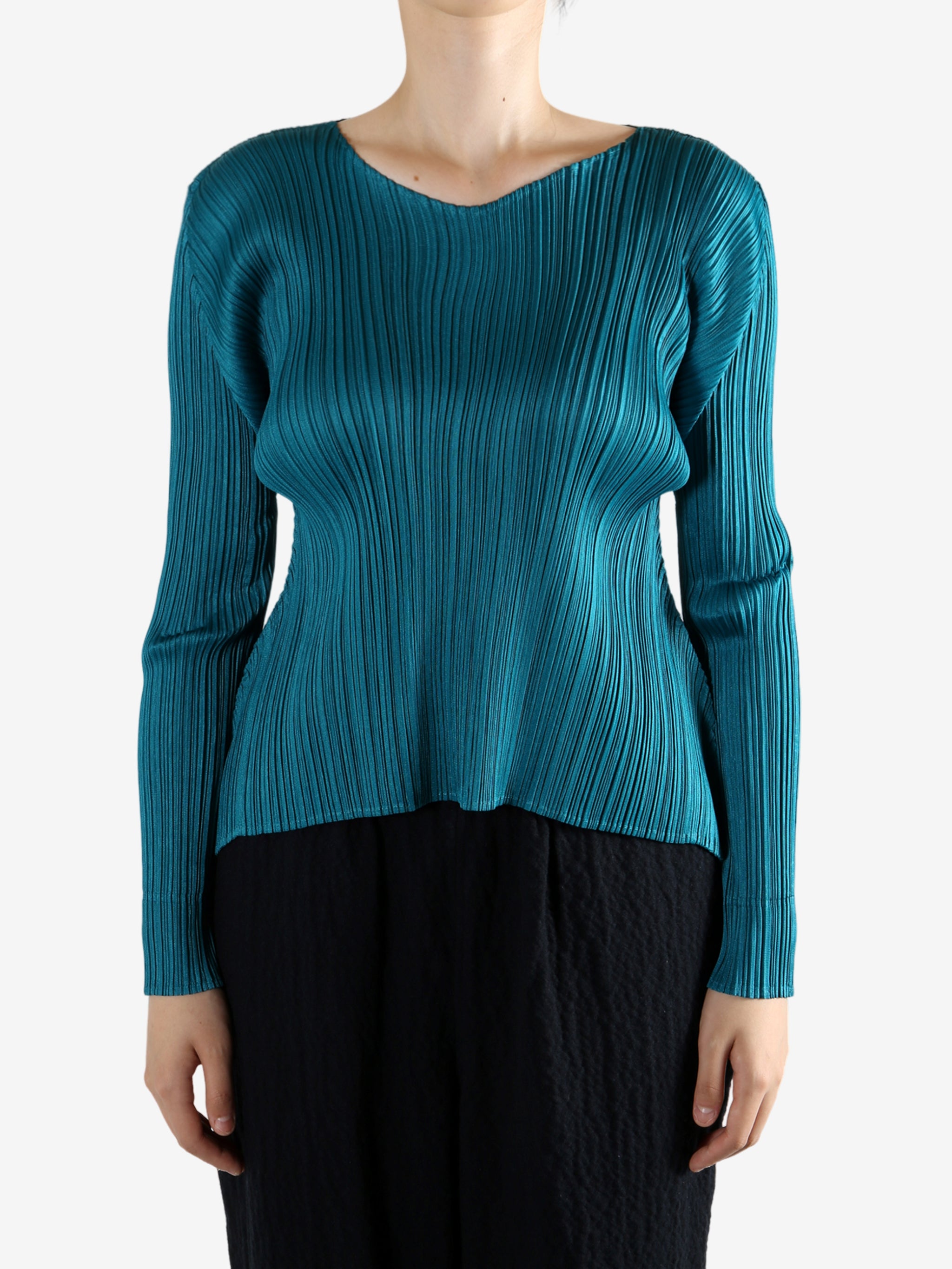 Green top worn by a person, showing the top fit