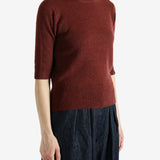 Red sweater worn by a person,showing the red sweater‘s fit