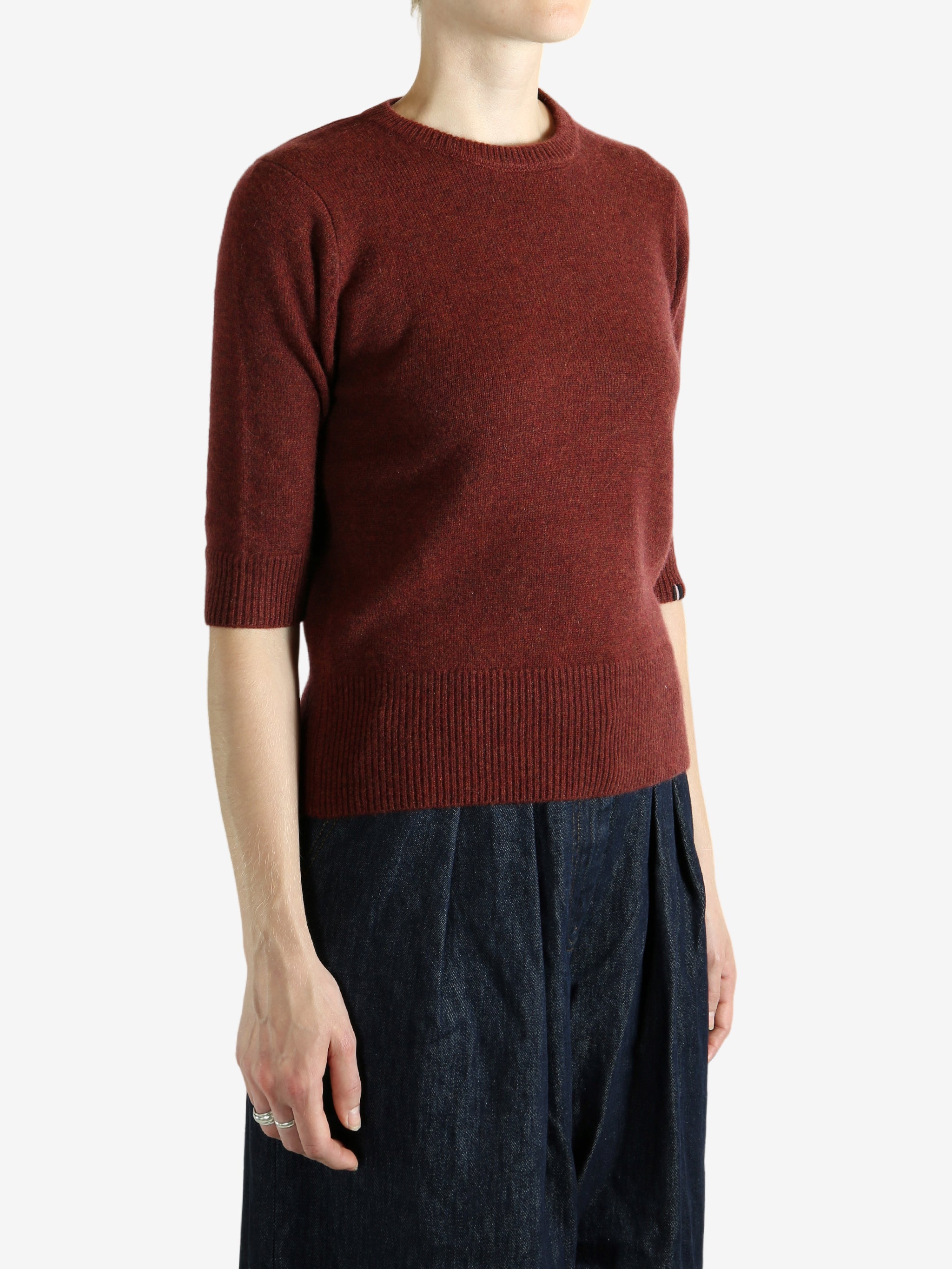 Red sweater worn by a person,showing the red sweater‘s fit