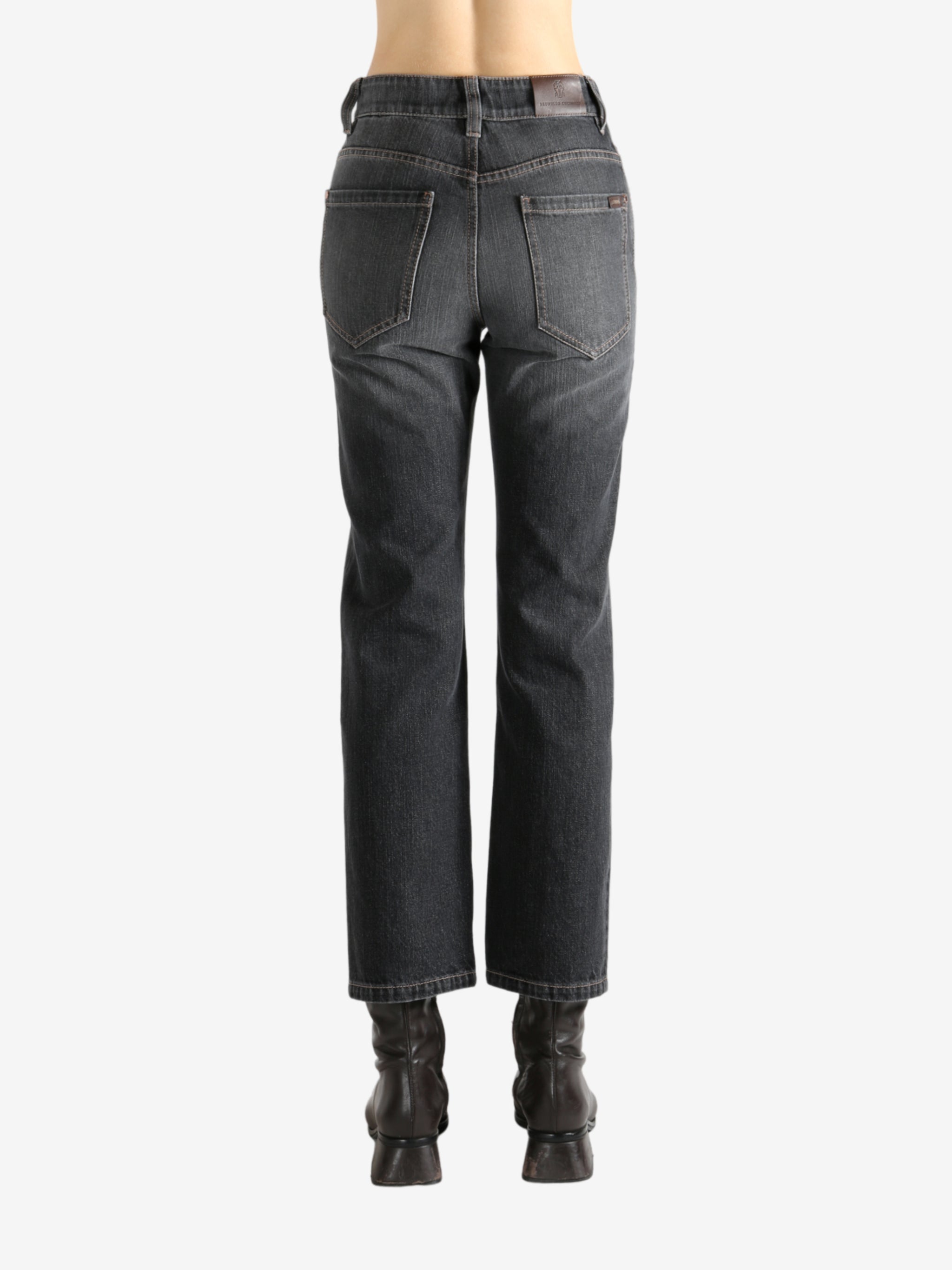 Black jeans worn by a person, showing the jean's fit