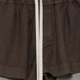 Close up of the brown shorts, showing texture of the cotton fabric
