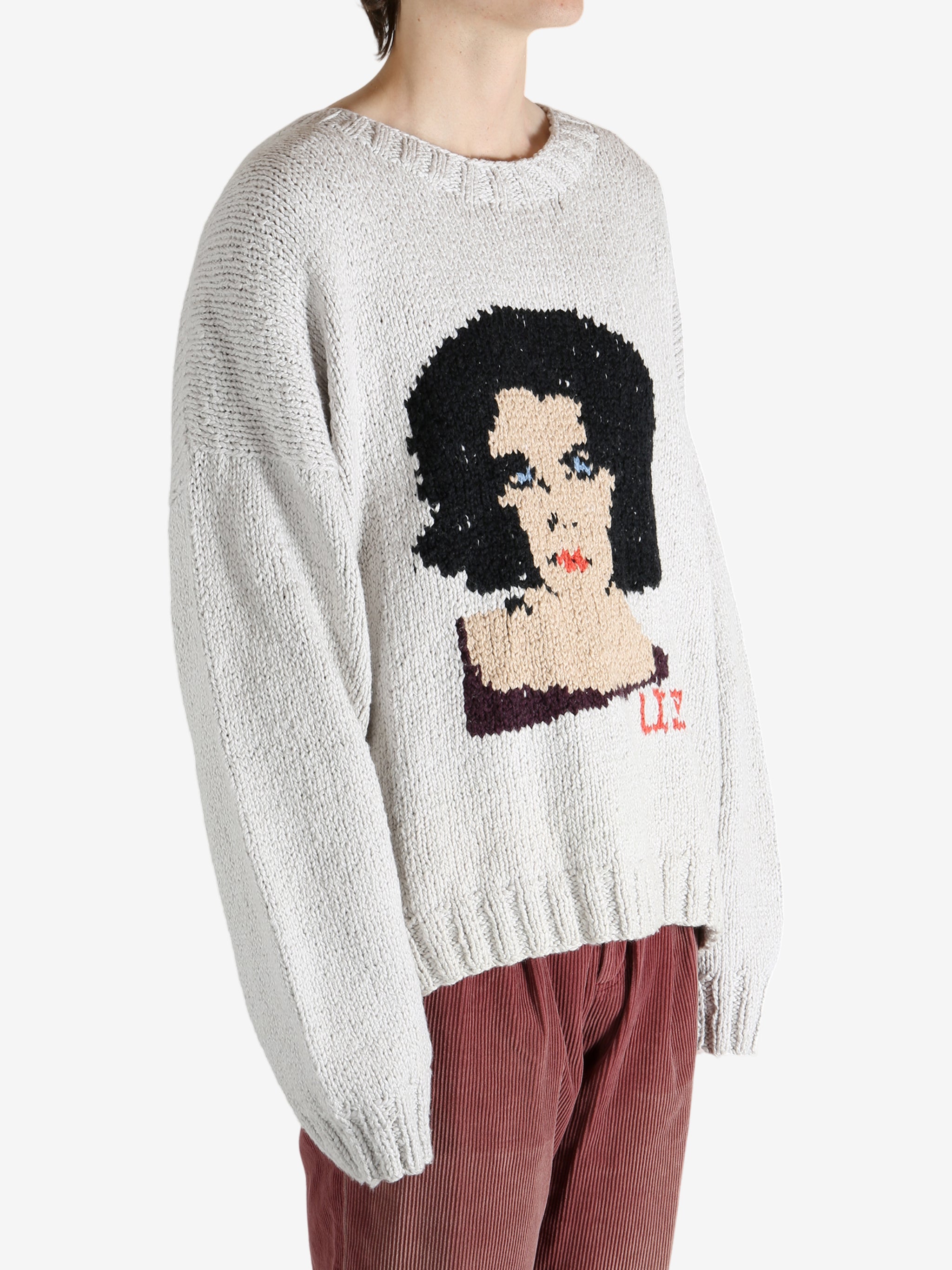 Grey sweater worn by a person, showing the sweater fit