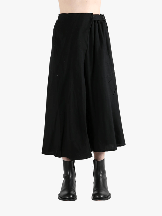Black skirts worn by a person, showing the skirts fit