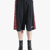 Black short worn by a person, showing the short's fit