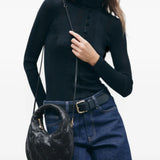 Black bag worn by a person, showing the bag fit