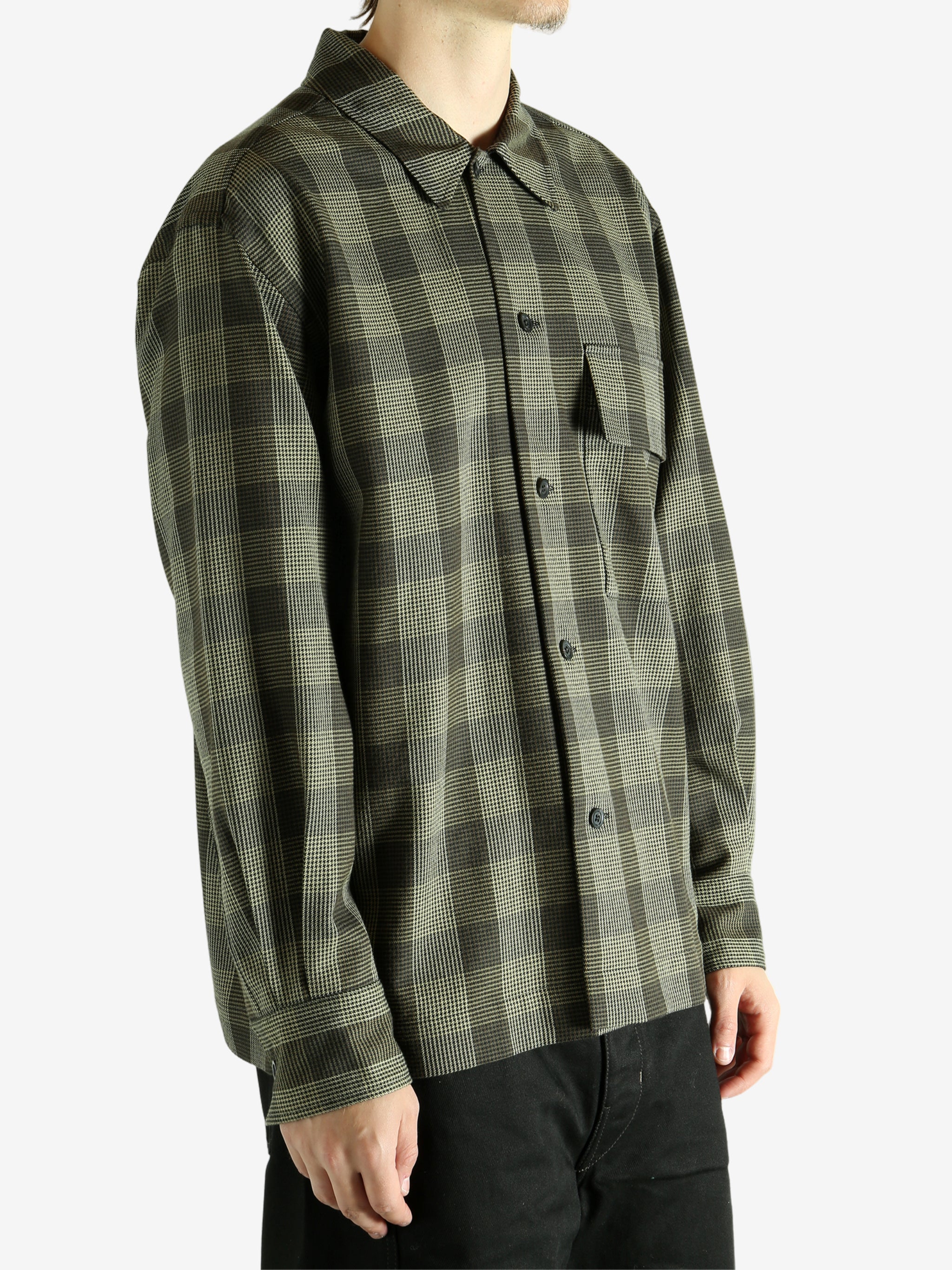 Black shirt worn by a person, showing the shirt's fit