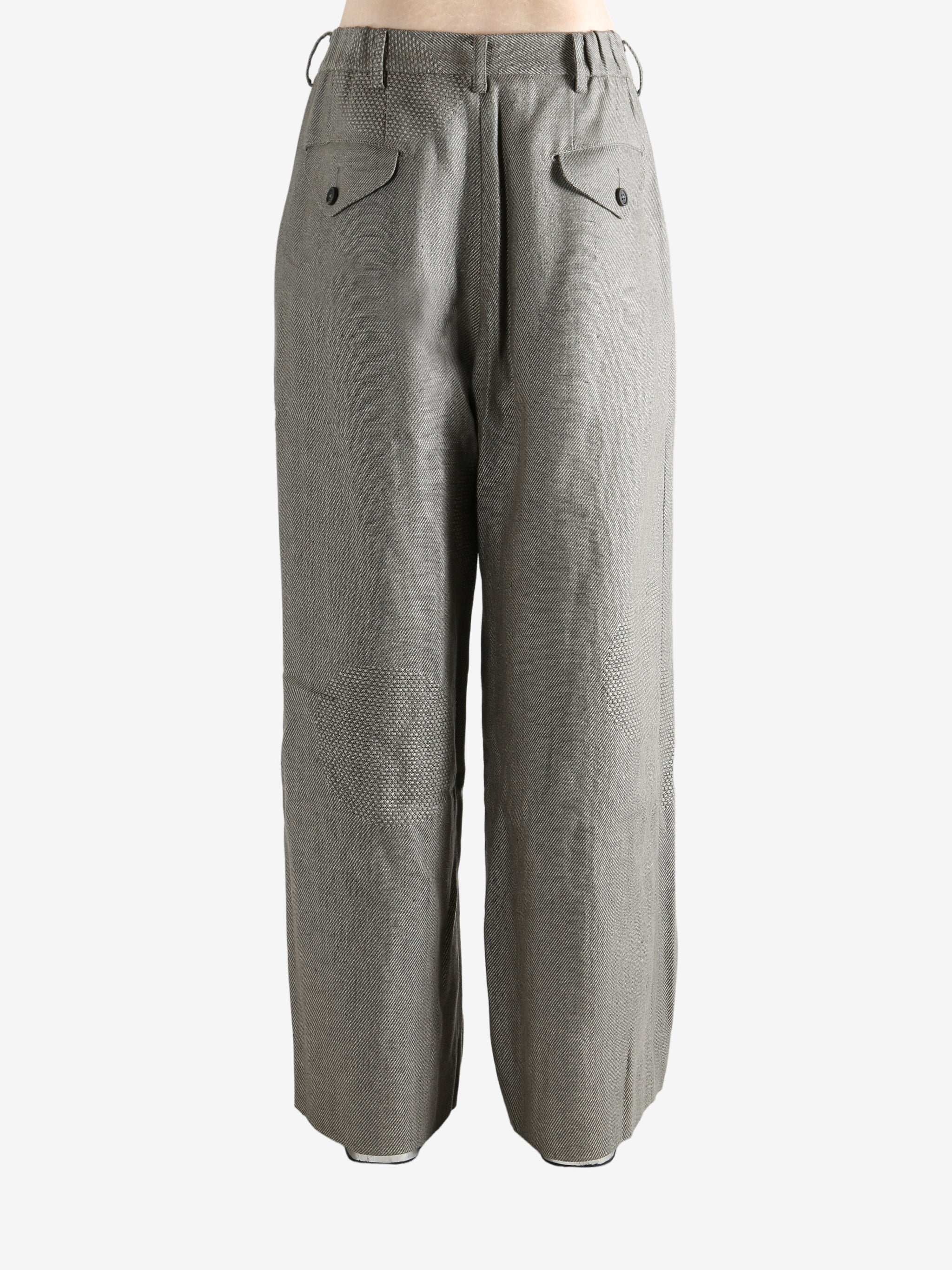 Grey pants worn by a person, showing the pants' fit