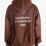 Brown sweats-hoodies worn by a person, showing the cotton fit