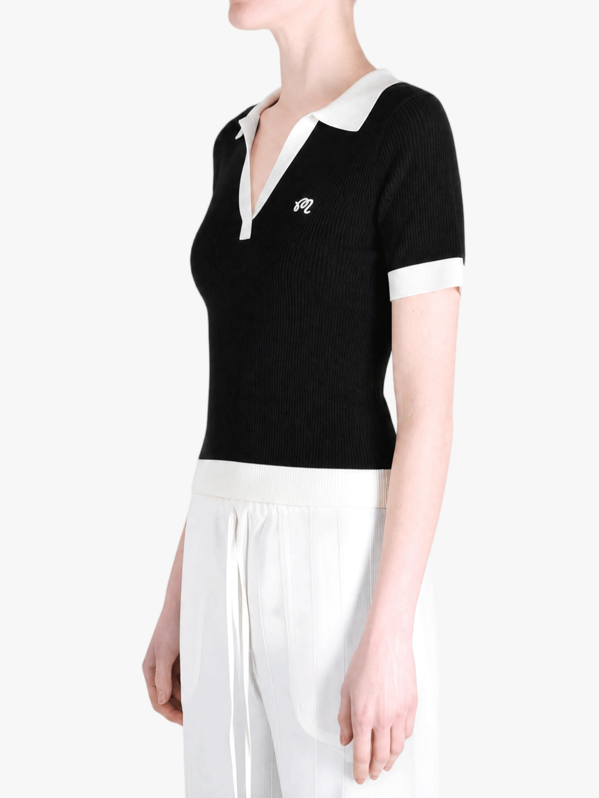 Black shirt worn by a person, showing the shirt fit