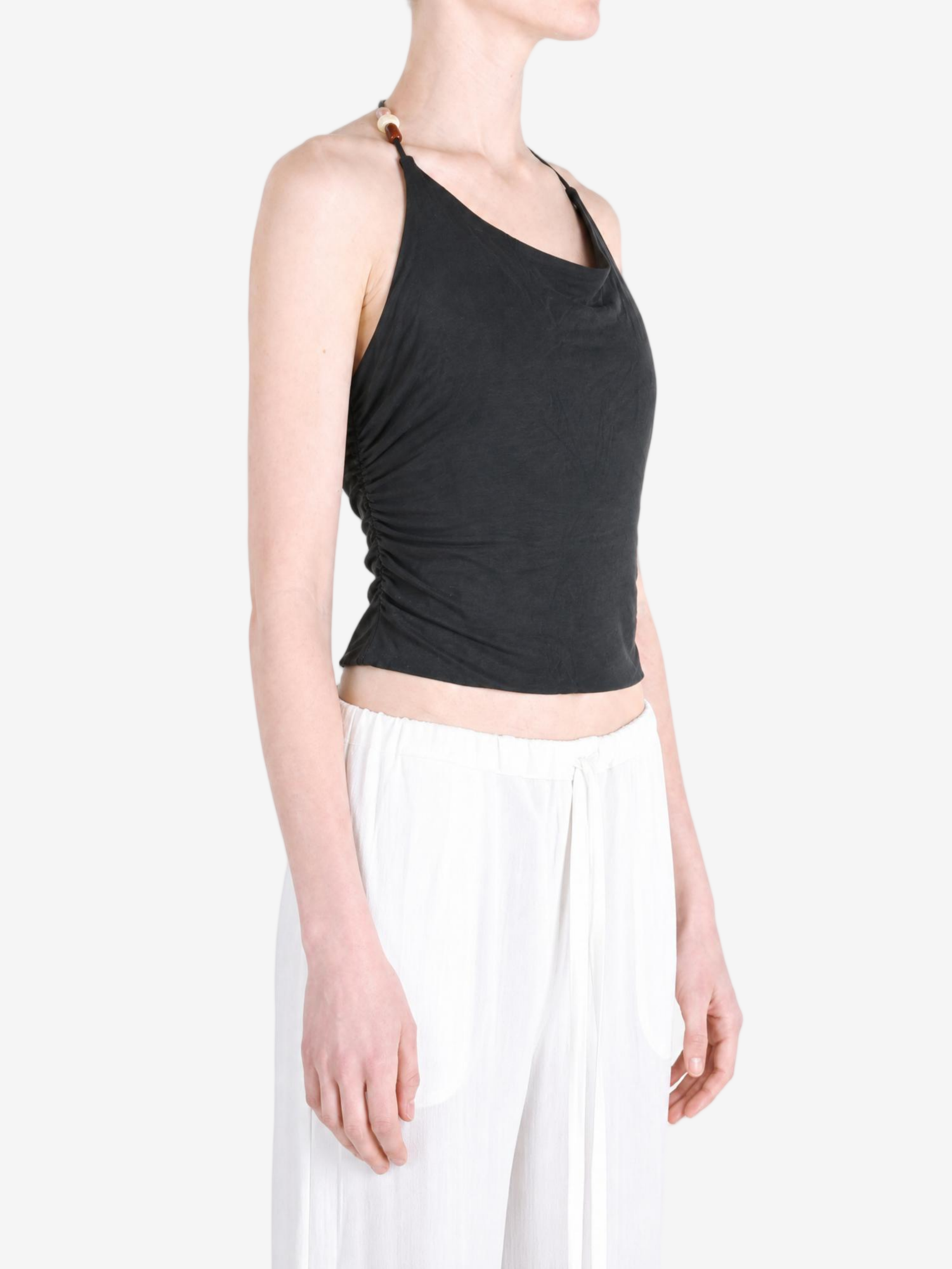 Black top worn by a person, showing the top fit