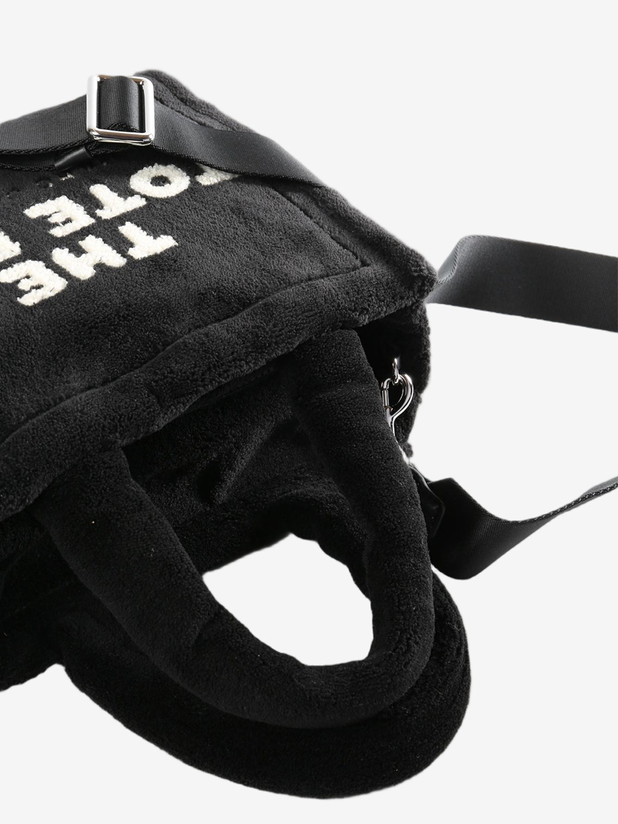 Close up of the black bag, showing texture of the polyester fabric