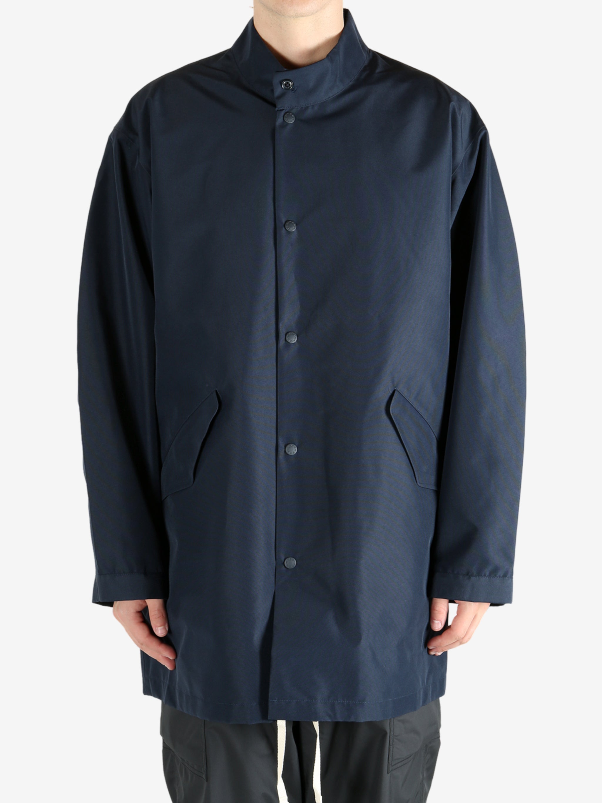 Navy jackets worn by a person, showing the jacket’s fit