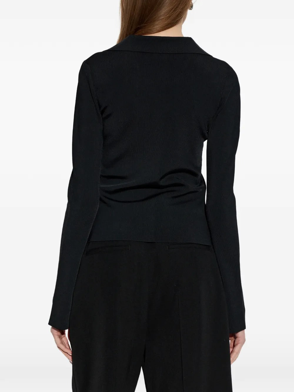 Black top worn by a person, showing the top's fit