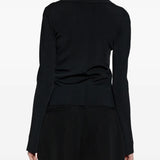 Black top worn by a person, showing the top's fit