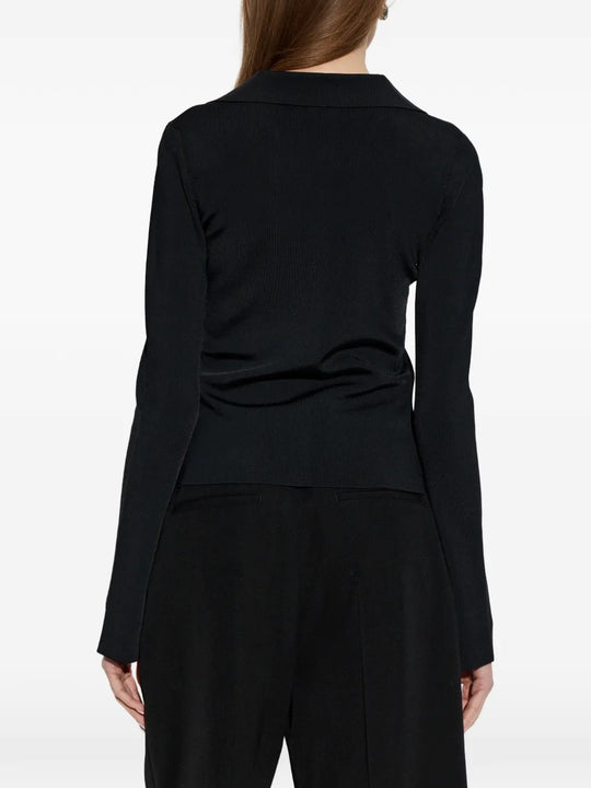 Black top worn by a person, showing the top's fit