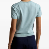 Green knitwear worn by a person, showing the knitwear fit