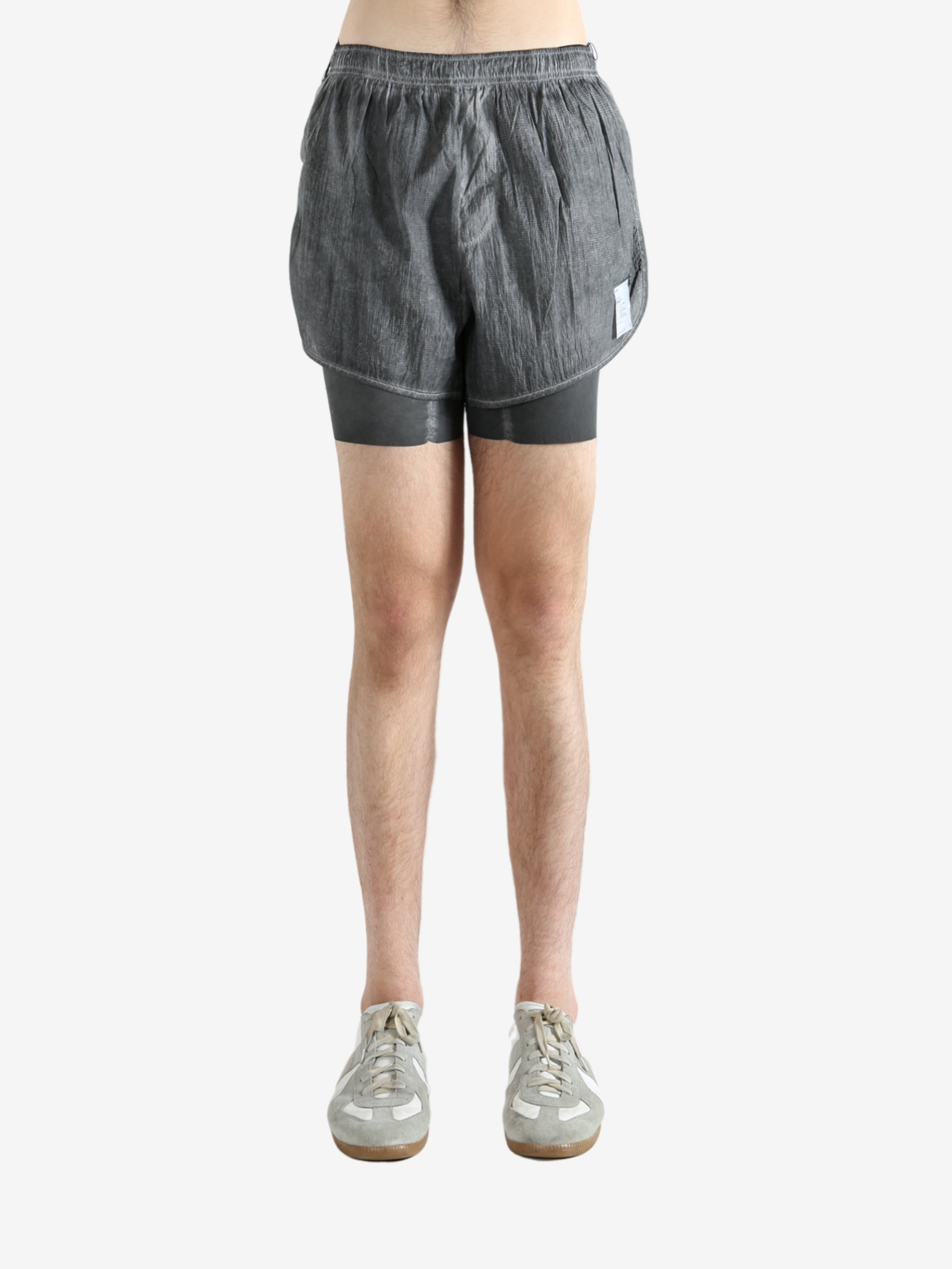 Grey shorts worn by a person, showing the shorts fit